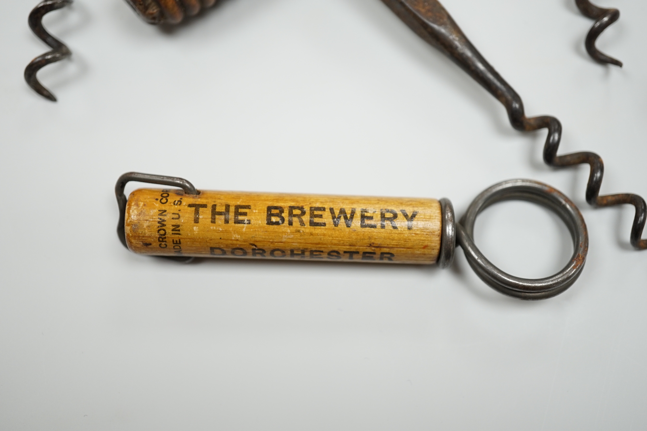 A 19th century iron corkscrew, with a turned wood handle and four other corkscrews (5)